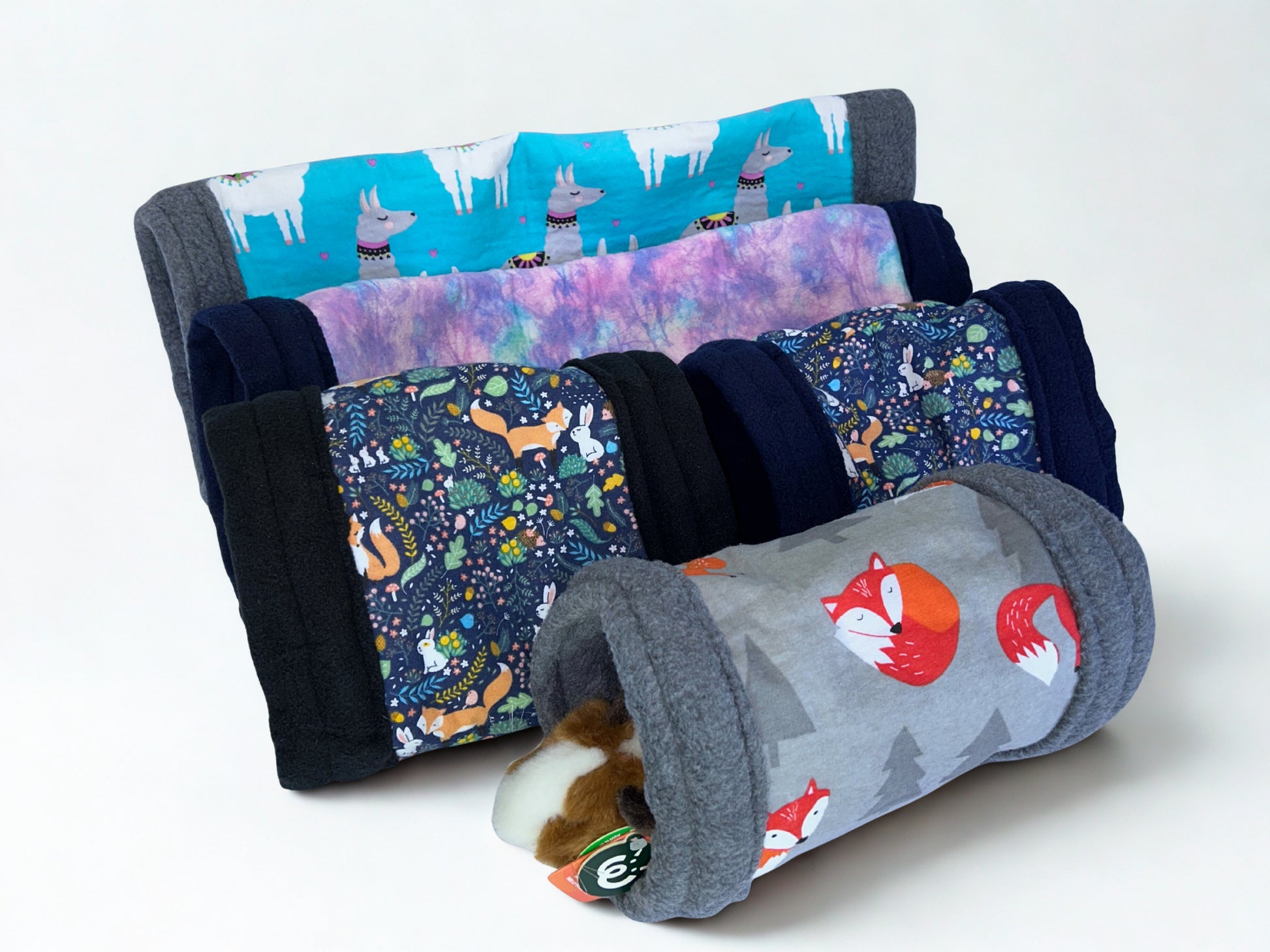 Set of colorful fabric tunnels with animal patterns on a white background